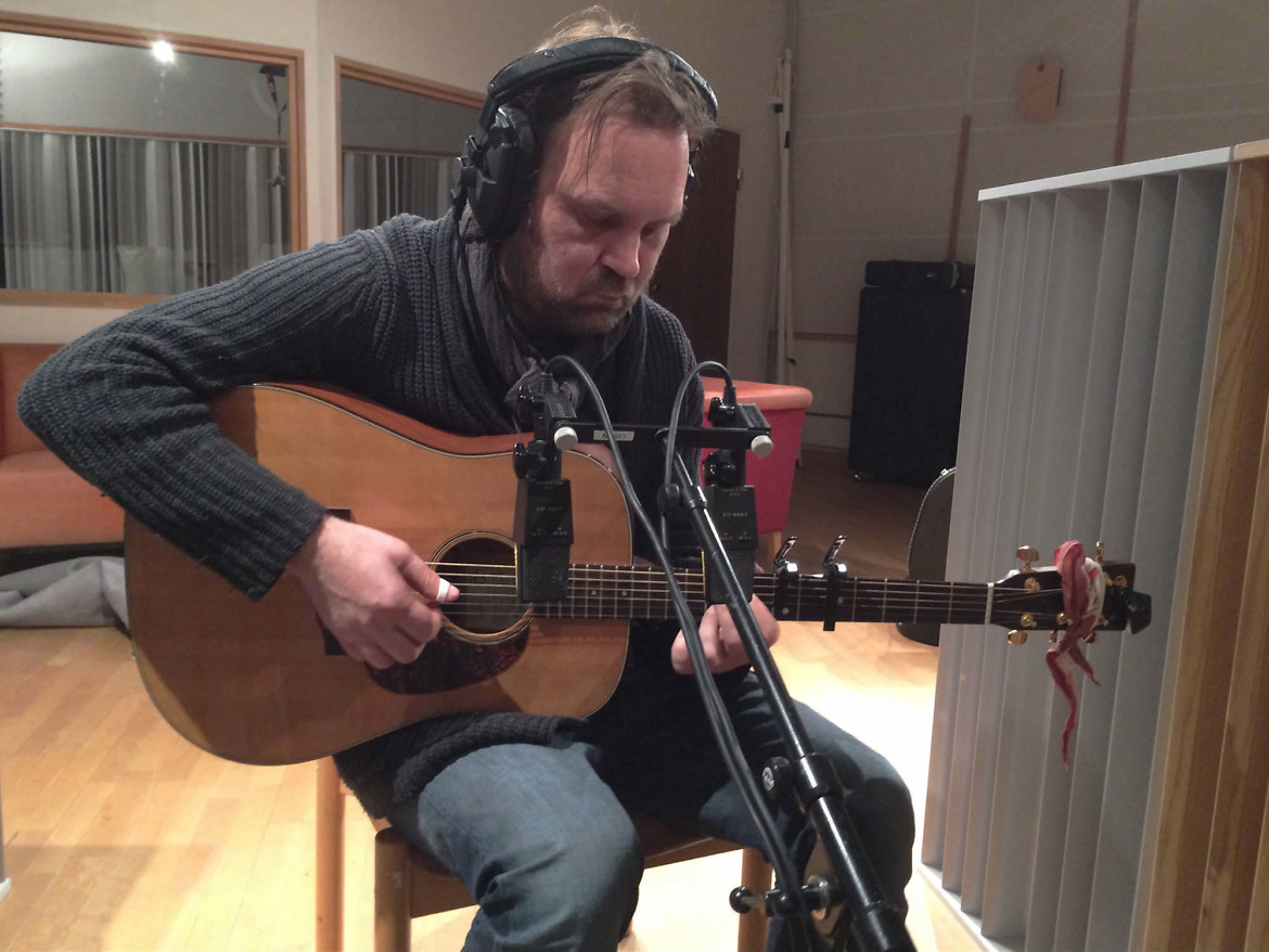 Inspelning av akustisk gitarr för Johan Seige, musiker i studions inspelningsrum.